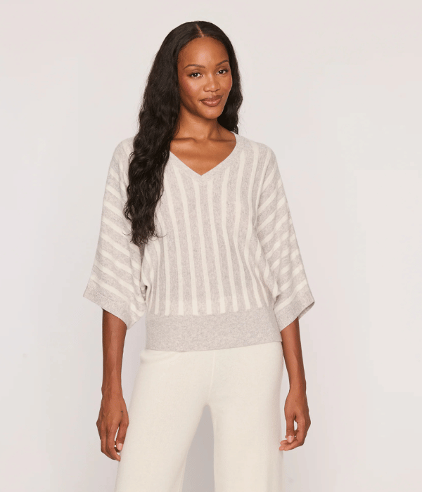 woman wearing a grey and white top