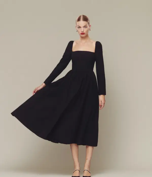 model wearing black dress with a full skirt