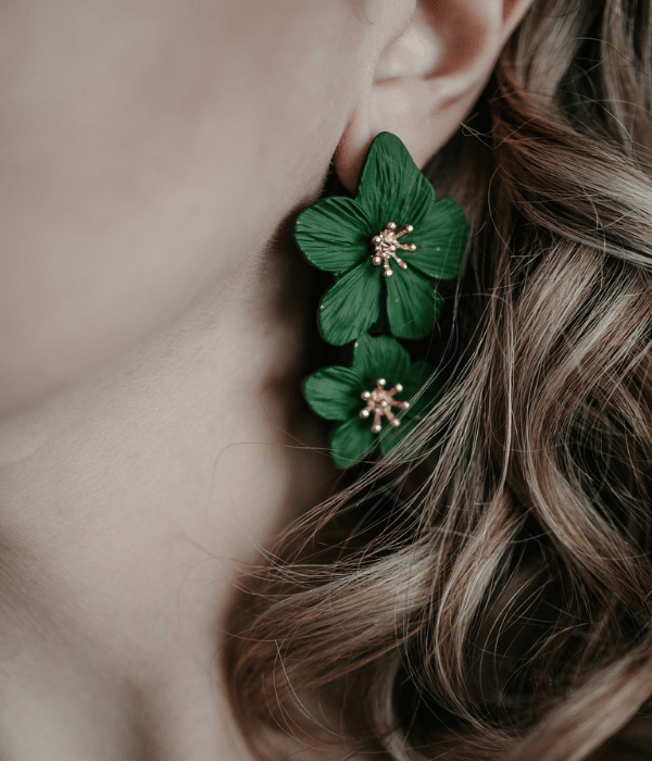 model wearing floral green earrings