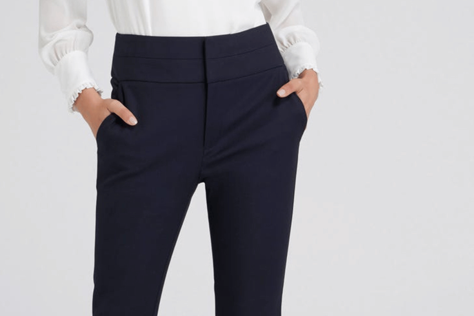model wearing black pants with side pockets and a white shirt