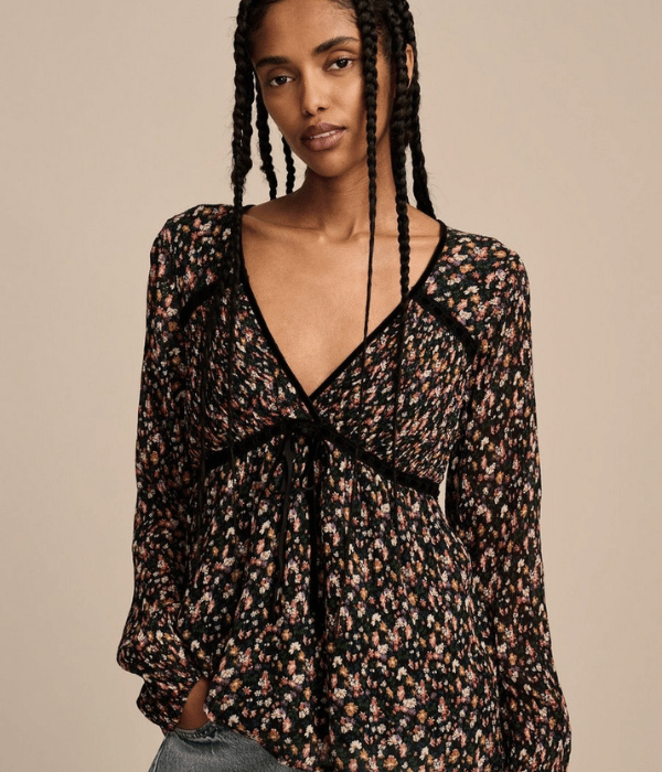 model wearing a floral v-neck top with jeans