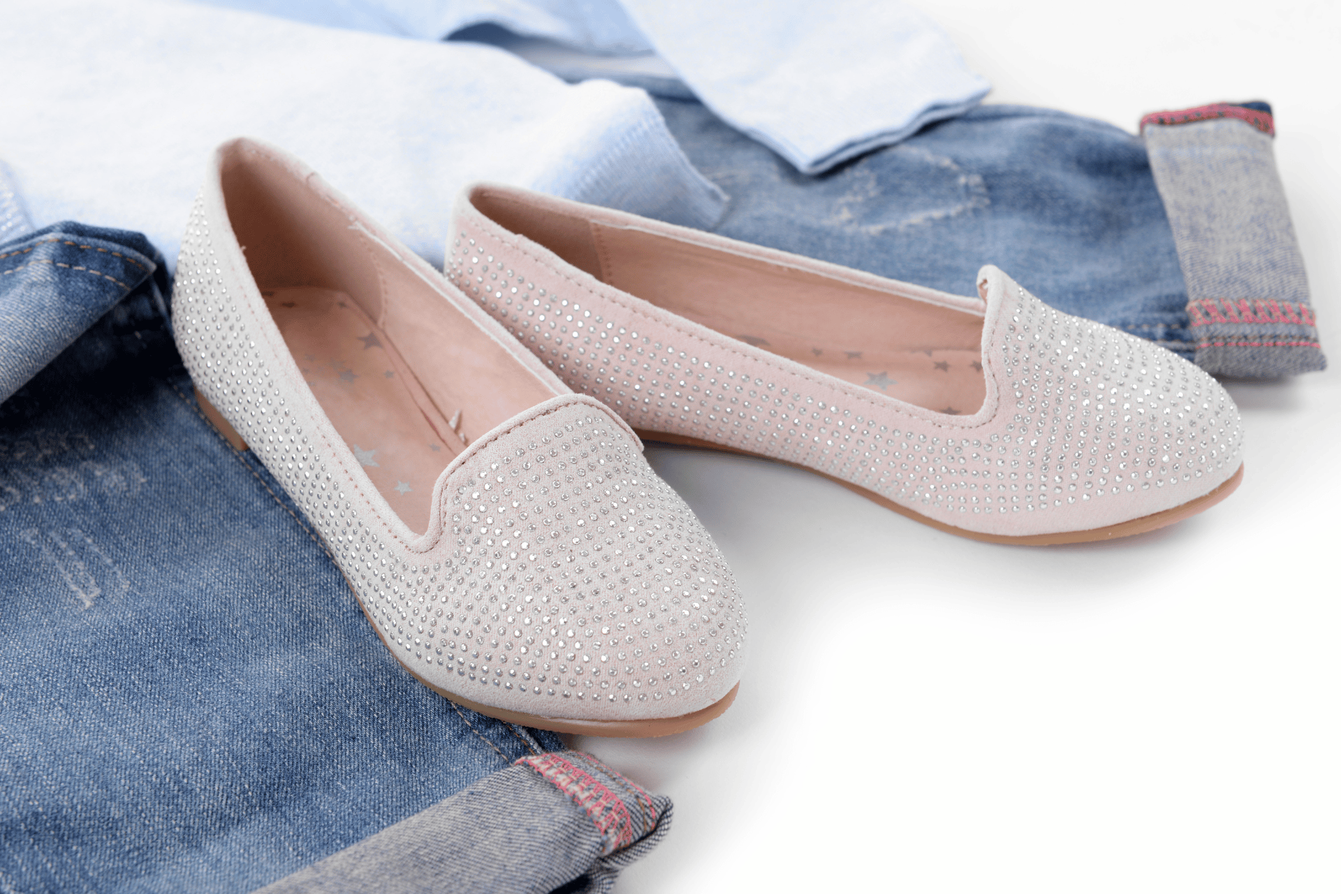 blue denim shoes on a white background with beige coloured shoes.