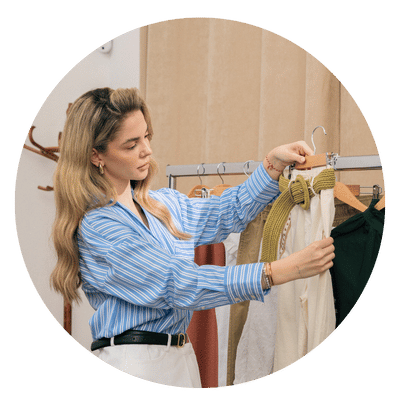 woman looking unhappy at a pair of pants on a hanger