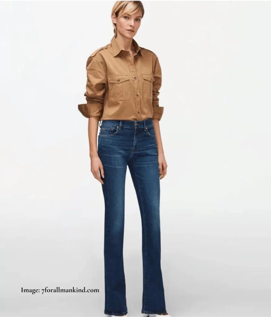 model wearing dark coloured bootcut jeans and beige shirt