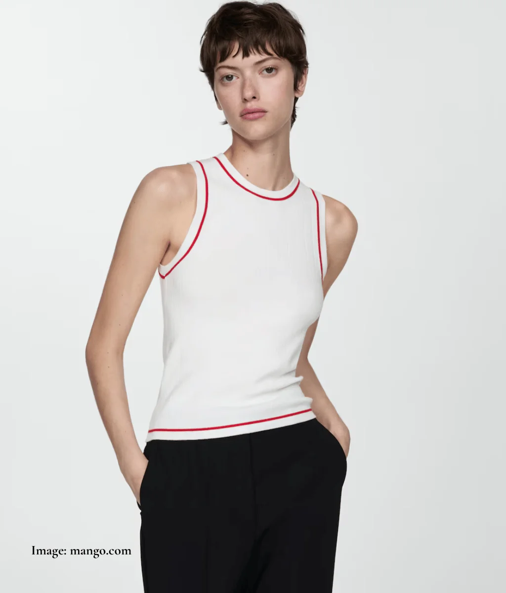 model wearing a white slim fit top with round neck, sleeveless and red trim