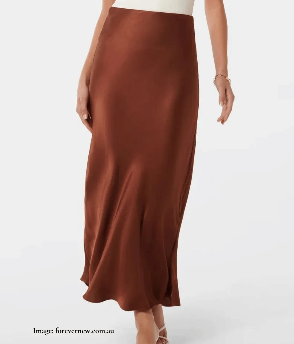 model wearing rust coloured bias cut midi skirt in satin