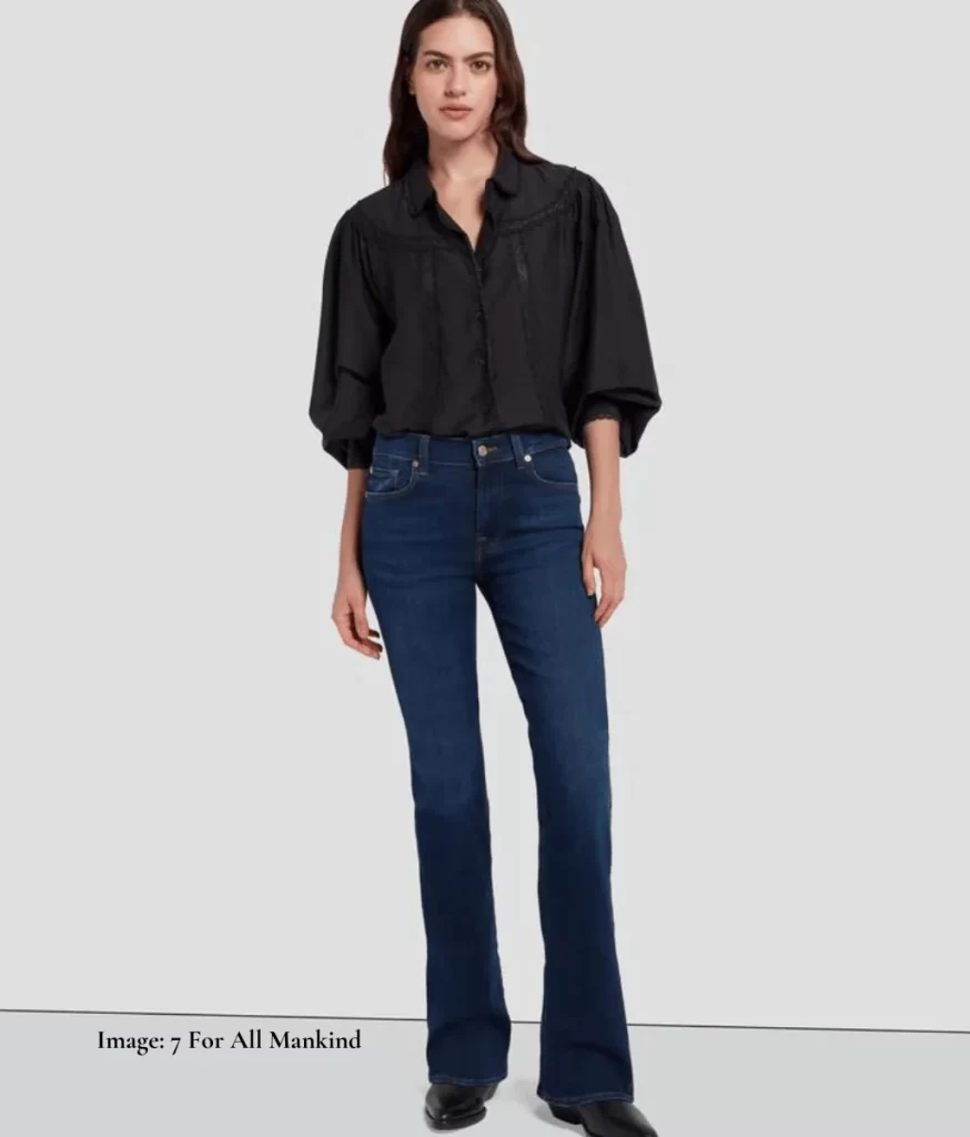 model wearing dark bootcut jeans & black shirt