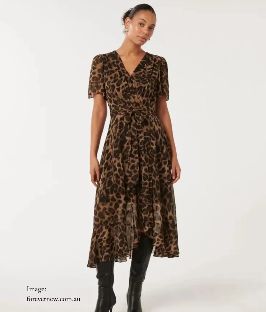 model wearing a wrap dress with a ruffle at the hem in an animal print