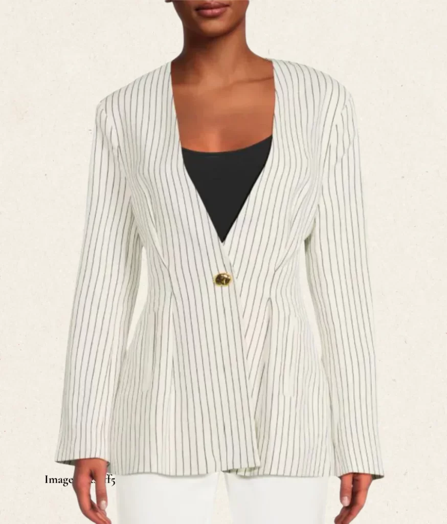 model wearing a collarless white one button jacket with black pinstripes