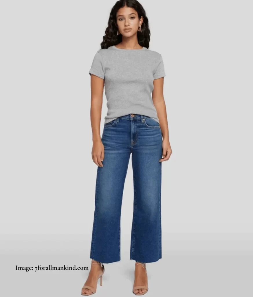 model wearing blue flared cropped jeans and grey t-shirt