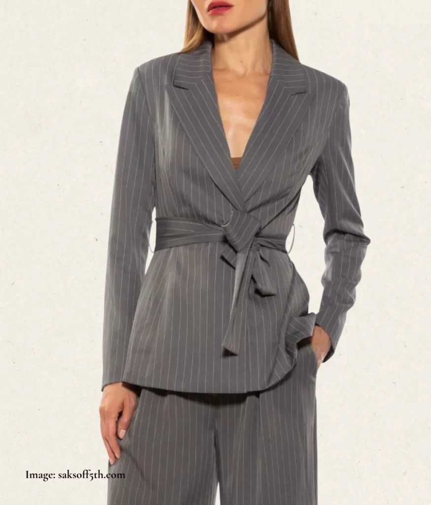 model wearing a grey jacket with a small collar and tie-waist