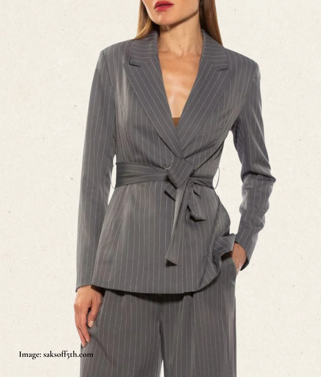 model wearing a grey jacket with a small collar and tie-waist