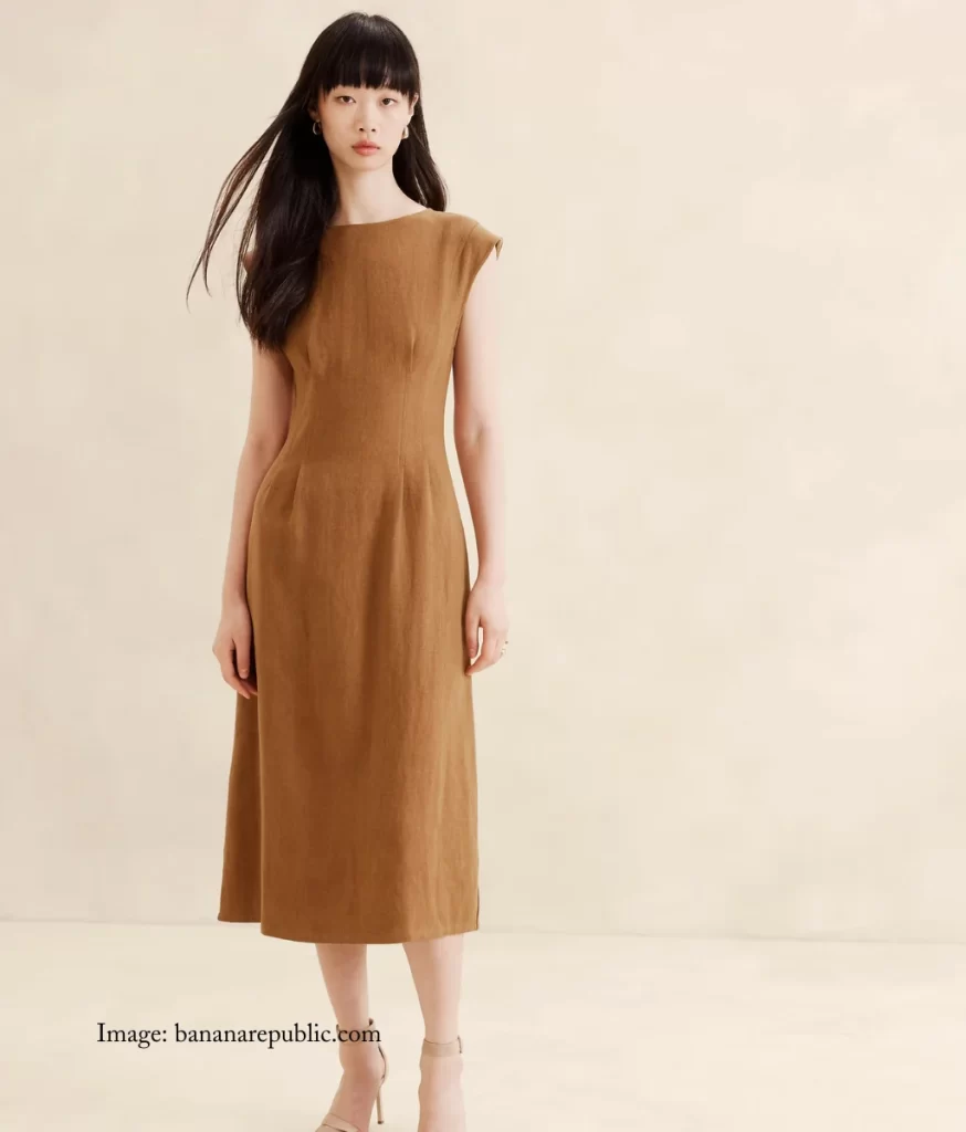 beige dress with tucks around the waistline to create shape