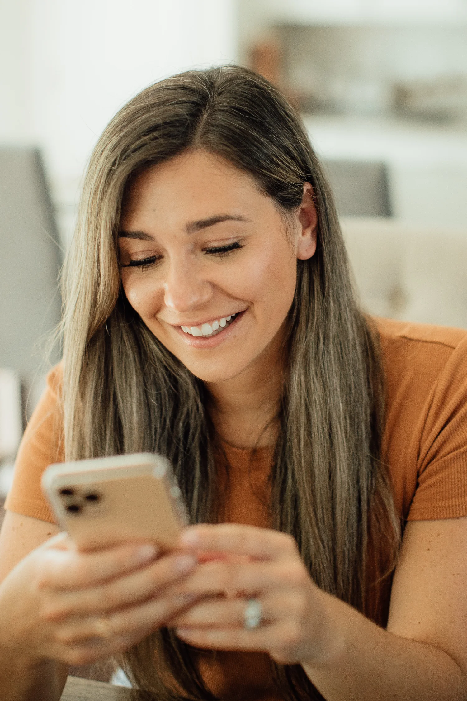 happy woman looking at her phone and smiling